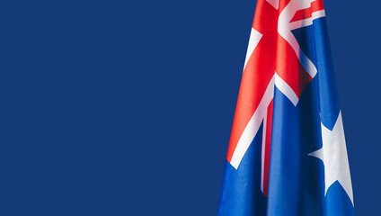 Close-up of the Australian flag is on the left side on a blue background