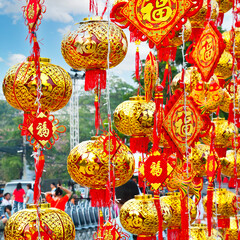 Chinese New Year lanterns in paper art form Happy New Year words written in Chinese characters in Chinese poetry.