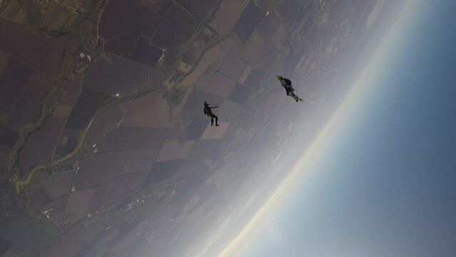 skydiving, acrobatics in the sky, a group of parachutists falling next to each other