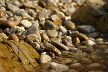 It is a stone that has been cut into a round pebble shape as the rock has been broken and eroded by waves and wind over a long period of time. To the touch, it is as smooth as silk.