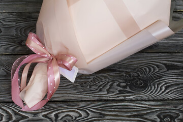 Elements of a bouquet wrapped in paper. Tied with ribbon. Marshmallow bouquet. Close-up.