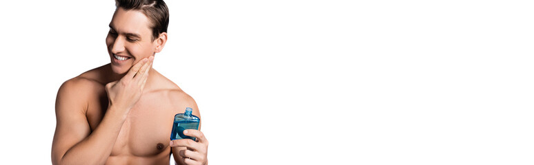 happy man with bare chest applying after shave lotion isolated on white, banner.