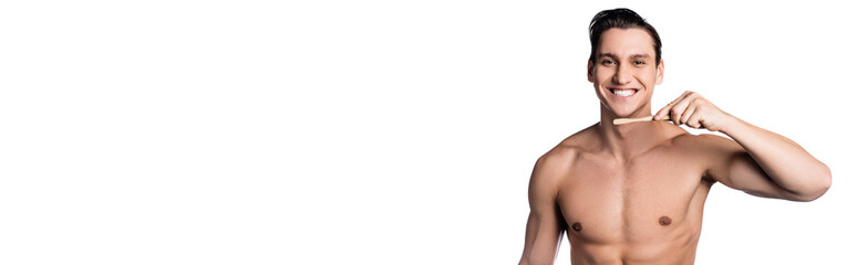 happy man with muscular body holding toothbrush isolated on white, banner.