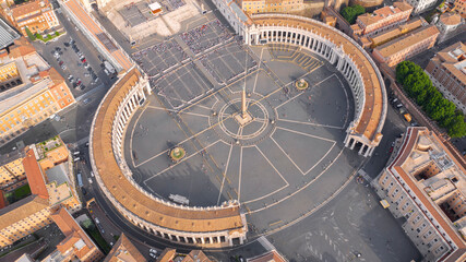Aerial view of the colonnade and St. Peter's square located in the Vatican city. This state is an enclave within the city of Rome, Italy. The obelisk in the center is known as 