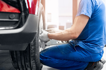 Professional mechanic changing tires. Concept car wheel service