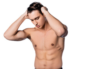 Obraz na płótnie Canvas shirtless muscular man touching hair while posing isolated on white.