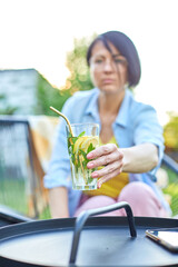 Fototapeta premium Woman take summer citrus lemonade with reusable metal straws