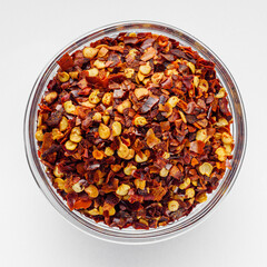 spicy chili flakes on a white background