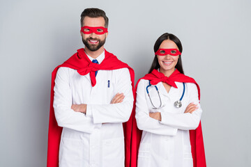Portrait of two attractive cheerful docs super team career folded arms save life isolated over grey color pastel background © deagreez