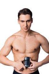 Fototapeta premium shirtless man with muscular body holding dry deodorant and looking at camera isolated on white.