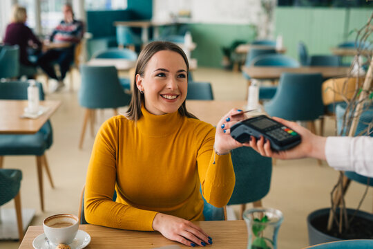 Woman Playing Contactless With Card In Restaurant