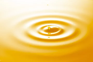 Fotobehang close up of vegetable oil drop with ripples. © zhane luk