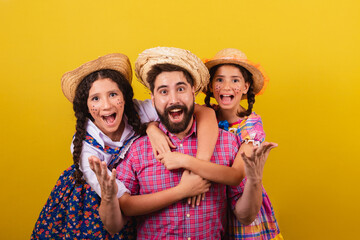 Father and daughters wearing typical clothes for the Festa Junina. Hugs, wow, incredible,...