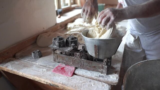 Weighing raw dough on a scale