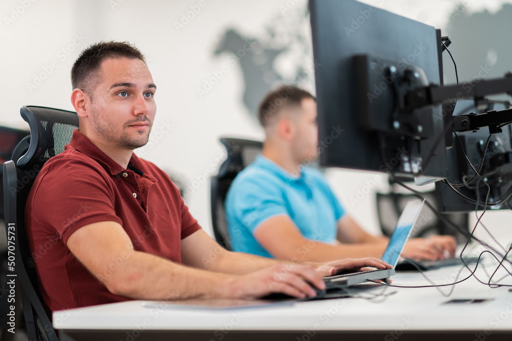 Wall mural group of casual business man working on desktop computer in modern open plan startup office interior