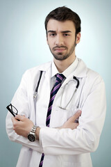 Confident Young Doctor with Glasses on His Hand