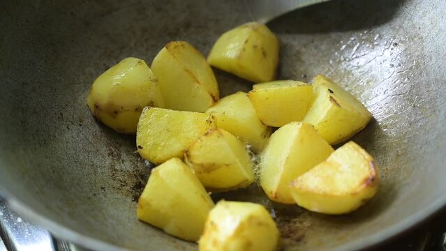 A few pieces of potato fry on mustard oil at Indian style.