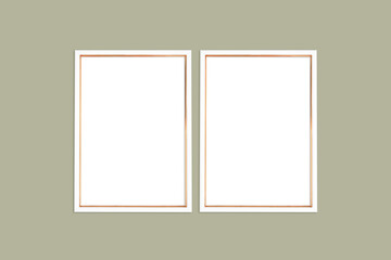 Two vertical white and gold frames on a khaki background