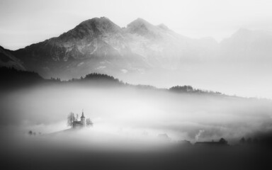 Saint Thomas church on a foggy morning in Slovenia