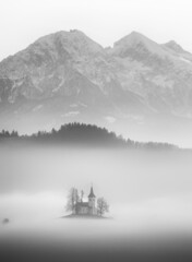 Saint Thomas church on a foggy morning in Slovenia