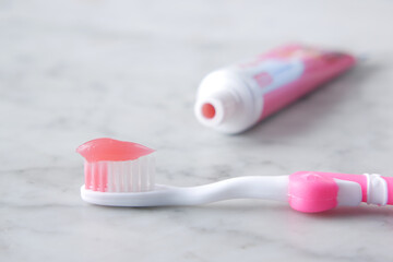  pink color child tooth brush with paste