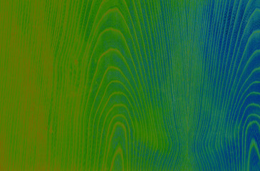 Abstract wood pattern in green, blue and orange tones. Artistic image processing created from wood veneer surface photo. Beautiful wooden texture background for any design.