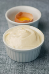 close up of Mayonnaise in container on table .