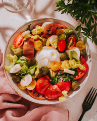 Fresh mediterranean salad with tomatoes and burrata cheese, top view