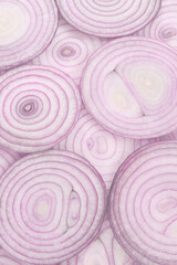 Fototapeta na wymiar Onion slices as a background. Top view.