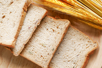 fresh bread with wheat ears on table 