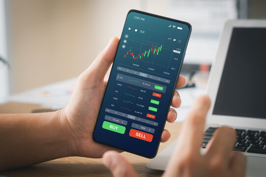 Businessmen work with stock market investments using smartphones to analyze trading data. smartphone with stock exchange graph on screen. Financial stock market.