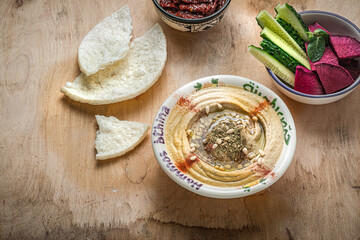Chickpeas hummus with olive oil and smoked paprika with cucumber and radish