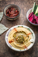 Chickpeas hummus with olive oil and smoked paprika with cucumber and radish