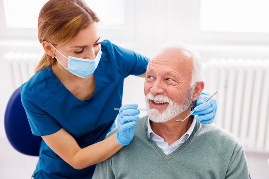 Dentist checking up patient at dental clinic