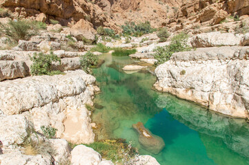 Tiwi, Oman - famous of its vertical cliffs and the green water, Wadi Shab is one of the most beautiful wadi in Oman, and a very popular tourist destination 