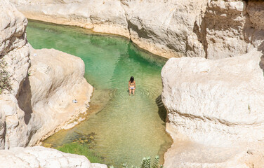 Tiwi, Oman - famous of its vertical cliffs and the green water, Wadi Shab is one of the most...