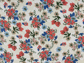 The red and blue floral flowers with leaves pattern on fabric