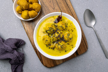 Kadhi Pakora, a Punjabi cuisine made with fritters dipped in curd based curry with gram flour and...