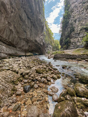 a shallow mountain stream flows among high rocks