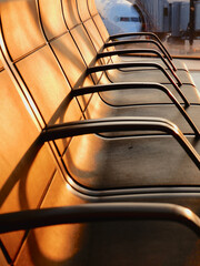 Empty armchairs in an airport lounge zone. Evening light. No people. Vertical photo