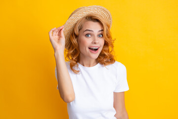 Expressive girl with surprised face. Beautiful woman in stylish straw hat on yellow background.