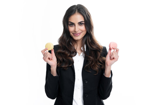 Beauty model girl taking colorful macaroons. Beautiful woman eating sweets macaron.