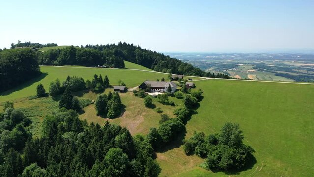 Drone view of a homes and landscape in Austria. Panorama among fields and alpine mountains in Tyrol, Dolomites
