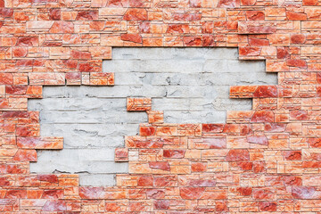 Broken colorful brick wall background outside of the building.