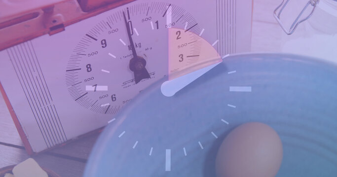 Image of clock over timer and eggs - Powered by Adobe
