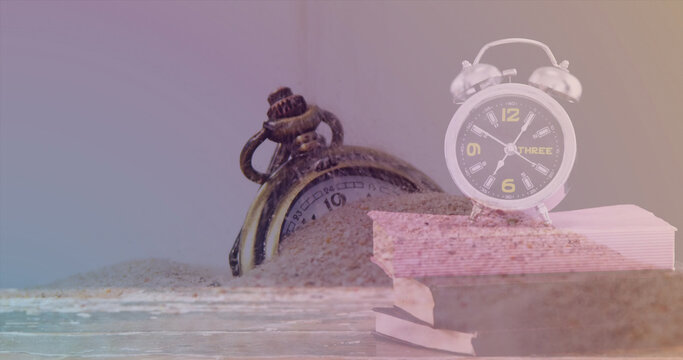 Image of clock over sand and timer - Powered by Adobe