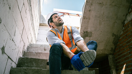 Engineer Worker Middle Eastern He was groaning,showing his feet injuredHandsome engineer injured his ankle when he stepped on a nail while inspecting a house project.Unsafe act,condition concept - obrazy, fototapety, plakaty