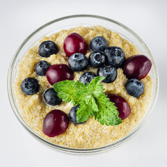 sweet porridge with quinoa and berries on a white background