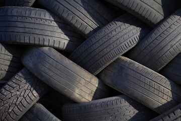 used tire pile garage waste for recycling black rubber background