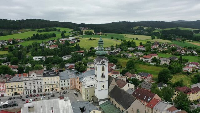 Drone view of the Altstadt Freistadt square. Old church, clock tower on the square in Austria, Tyrol